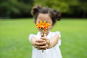 ילדה נותנת פרח כמו שפירוש חלומות נותן תובנות חשובות לחולם